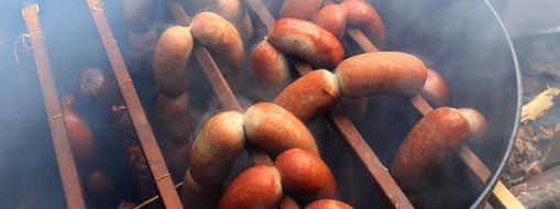 smoking of delicious sausages on grill