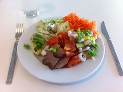 healthy dinner on a white plate on the table