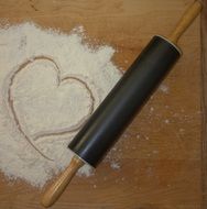 Rolling pin and heart form in the flour
