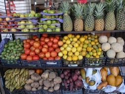 fruits and vegetables in black boxes on the shelves in the market