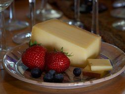 Parmesan, strawberries and blueberries on a plate