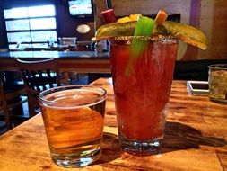 glass of apple juice and bloody mary cocktail