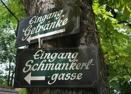 cozy direction signs on tree, germany, bavaria, beer garden