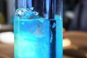 blue cocktail with ice closeup