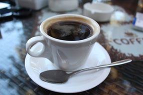 cup of coffee with a saucer and spoon