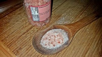 pink salt in a wooden spoon