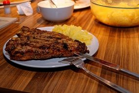 dish of fried steak T-Bone and potato salad