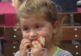 girl is eating a pie