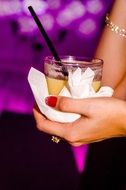 cocktail in a female hand at a party