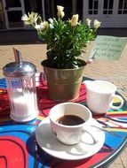 cup of espresso, sugar and cream on the table