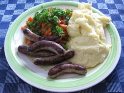 mashed potatoes with sausages on plate