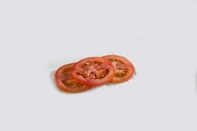 Sliced red tomato on the white surface