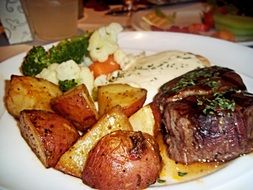 steak with potatoes and vegetables
