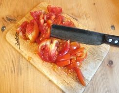 tomato cut with a big black knife