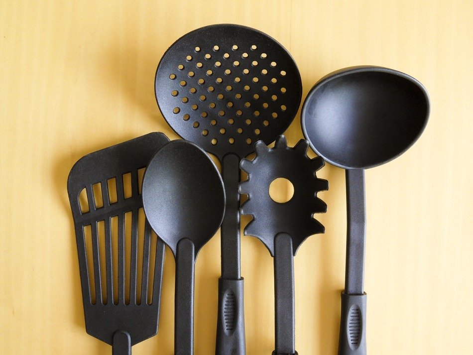 Blac cookware for cooking on the wooden surface