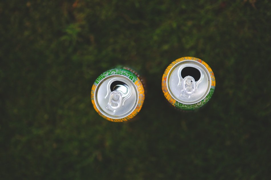 two cans on a grass