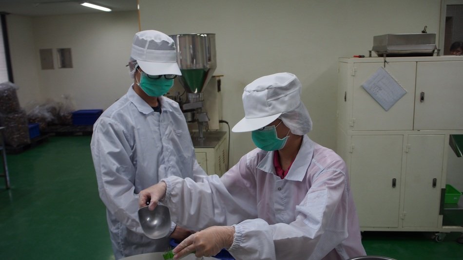 workers in white coats at a food factory