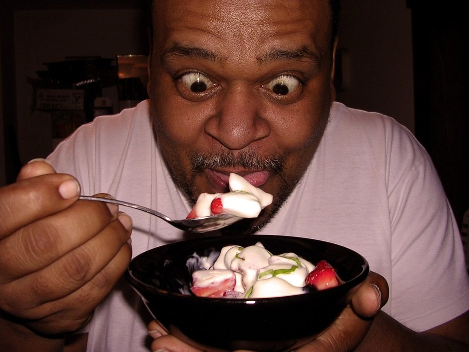 surprised mature dark skin man eating dessert