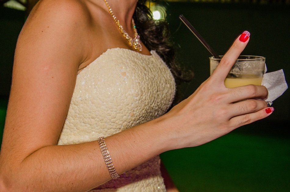 drink in woman’s hand at night