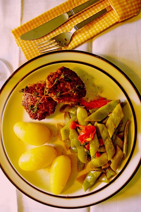 cutlets with potatoes and colorful beans in the bowl