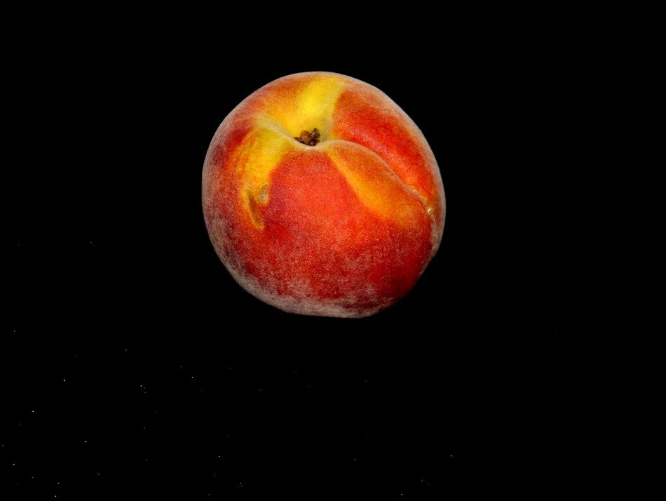ripe sweet peach on a black background
