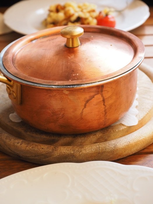 Brass pot with food