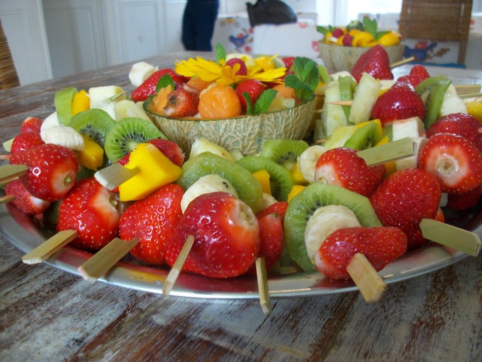 Fruits on skewers on the plate