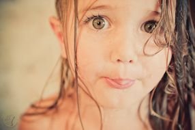 cute girl with big eyes after bath