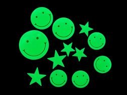 neon emoticons and stars on a black background