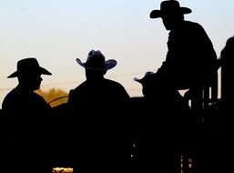 Black silhouettes of cowboys with the hats clipart