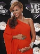 pregnant singer Beyonce in a red dress