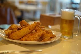 chicken appetizer and glass of beer