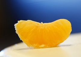 Orange slice on a white surface