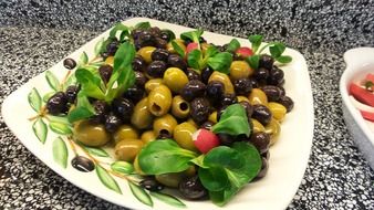 black and green olives on a white plate