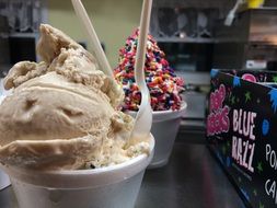 creamy ice cream in a cup and creamy ice cream with sweets