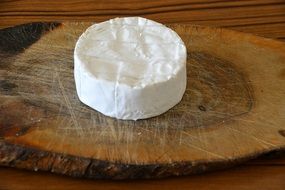 Round White camembert cheese on wooden board