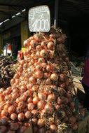 a bunch of onions on the counter with the price tag