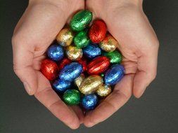 Easter sweets in the form of eggs in the hands