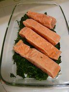 frozen salmon on spinach