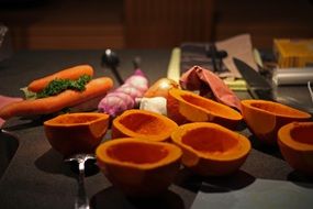 peeled pumpkin and vegetables on the table in the kitchen