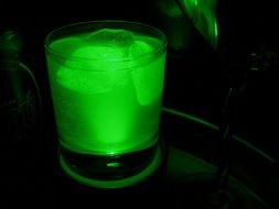 glass of shining cocktail drink with ice