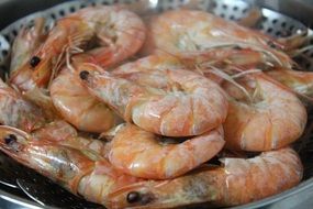 Boiled shrimps on a black plate