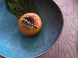 persimmon in the blue dish