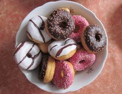 different donuts in a white plate