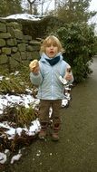 baby with sausage in hand