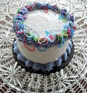 white cake decorated with multicolored cream