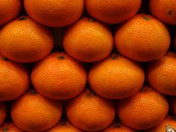 tangerines are stacked next to each other