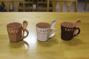 three cups with tiramisu on the table in Japan