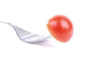 red tomato on the fork