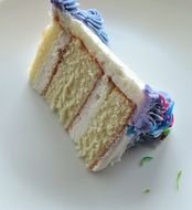 slice of white layer cake on a white plate